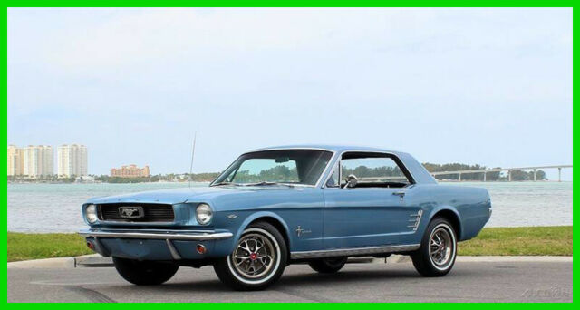1966 Ford Mustang Silver Blue with a black comfort weave bucket seat interior