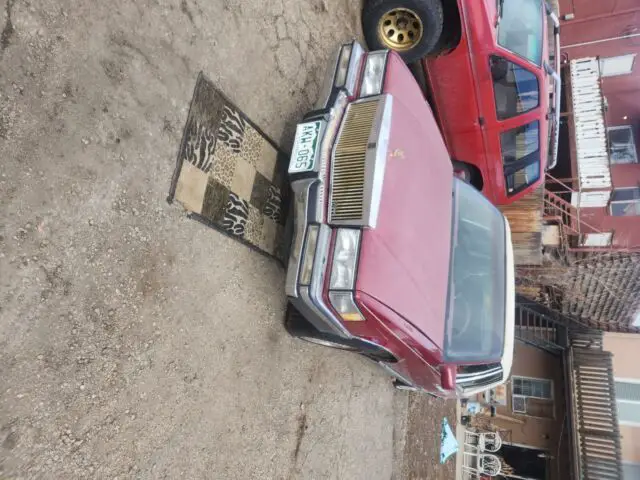 1991 Cadillac DeVille Silver and gold with a white leather roof