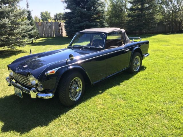1966 Triumph TR4A Wool carpets, black leather seats with white piping,